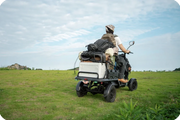 EUNORAU S1000 cargo quad transporting equipment and bags across grassy property